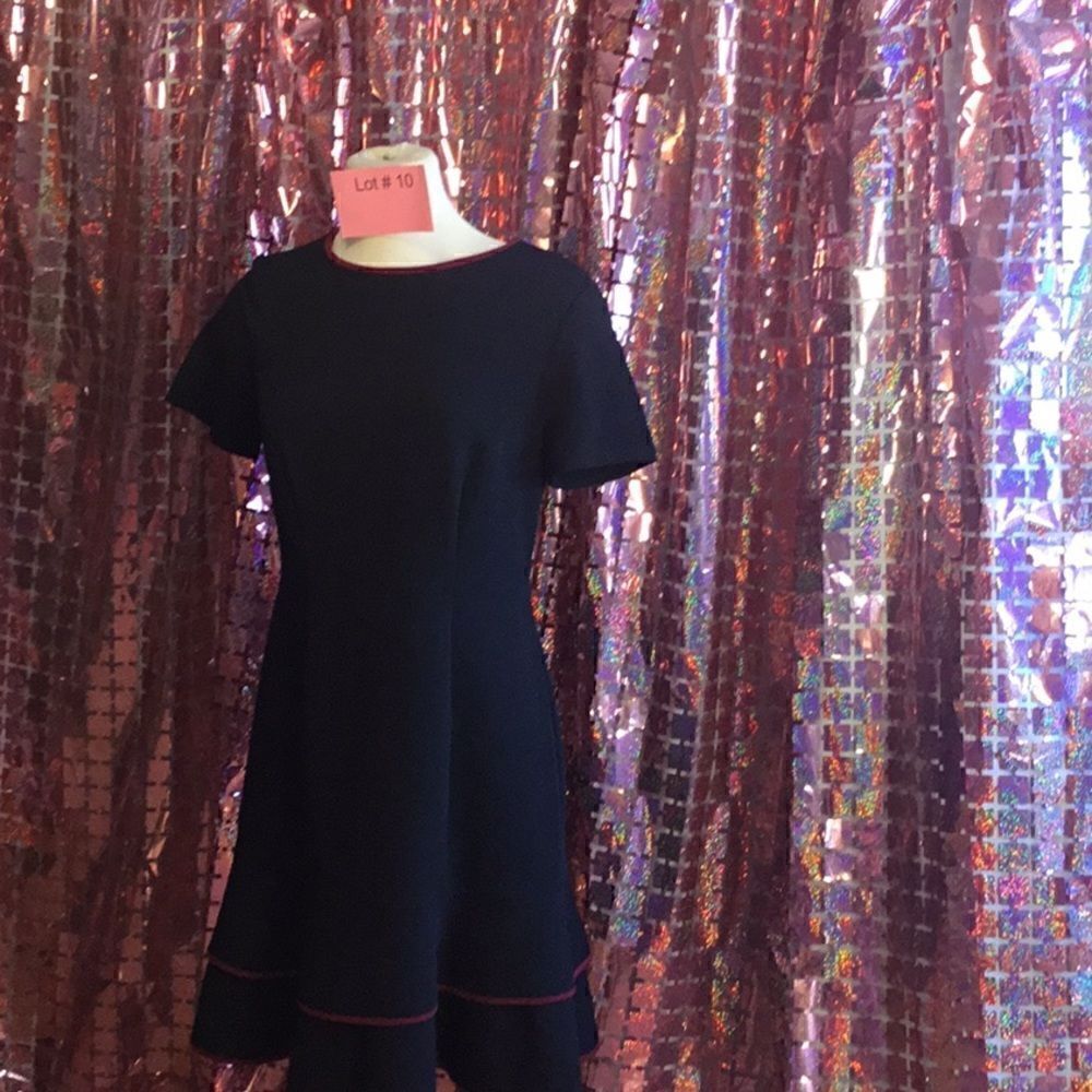 Black poly blend dress with ruffled skirt hem & deep mauve colored trim